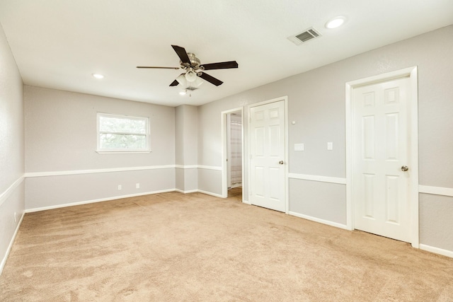 unfurnished bedroom with ceiling fan and light carpet