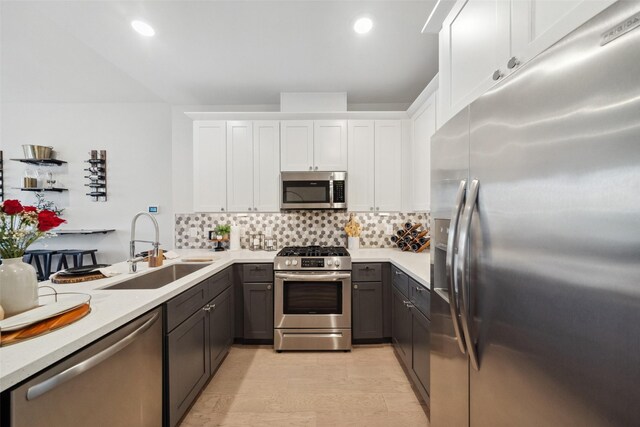 kitchen featuring a sink, light countertops, white cabinets, and stainless steel appliances