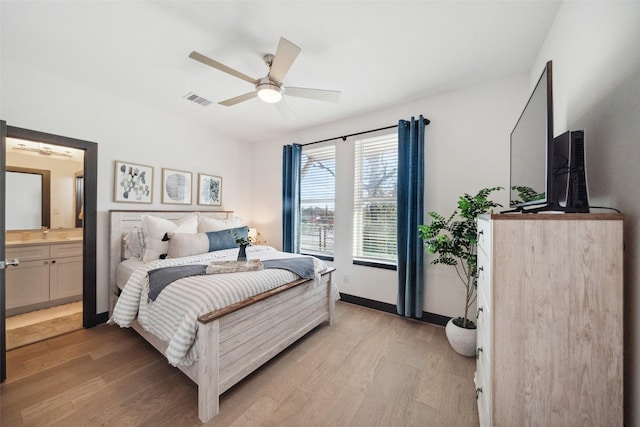 bedroom with ceiling fan, ensuite bath, and light wood-type flooring