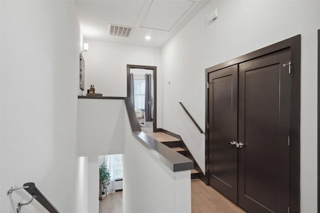 staircase with hardwood / wood-style flooring