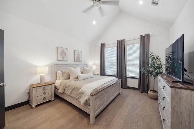 bedroom with ceiling fan, light wood-type flooring, and high vaulted ceiling