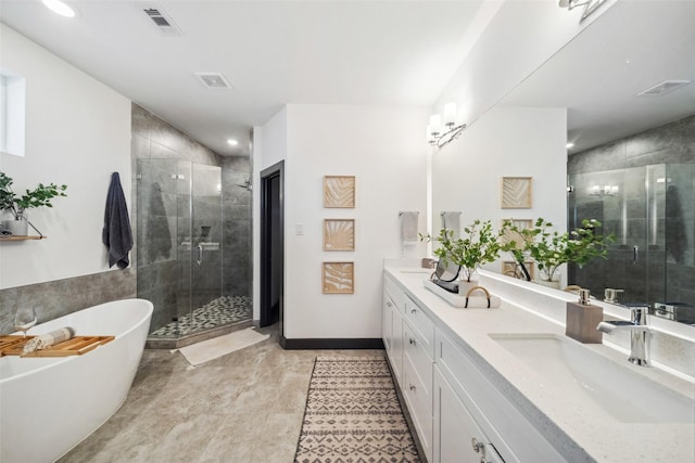 bathroom featuring a sink, visible vents, a freestanding bath, double vanity, and a stall shower