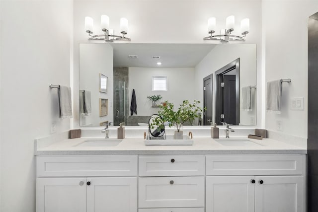 bathroom with a chandelier, walk in shower, and vanity