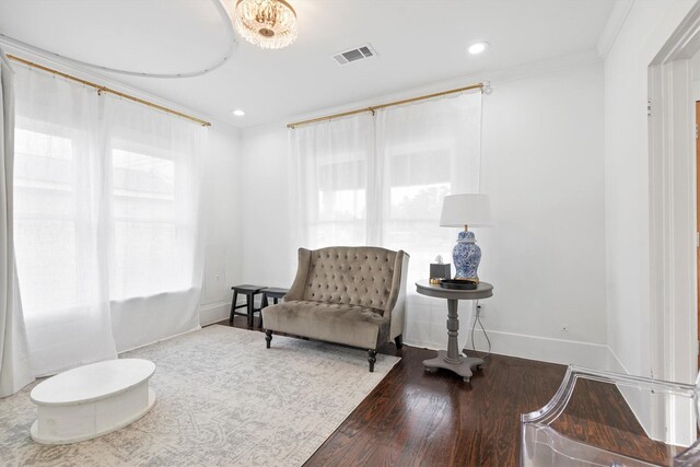 living area featuring crown molding and hardwood / wood-style floors