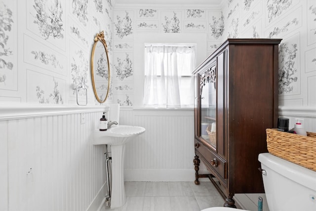 bathroom with toilet and tile patterned flooring