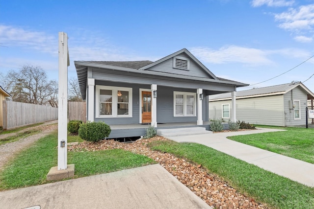 view of front of house with a front yard and covered porch