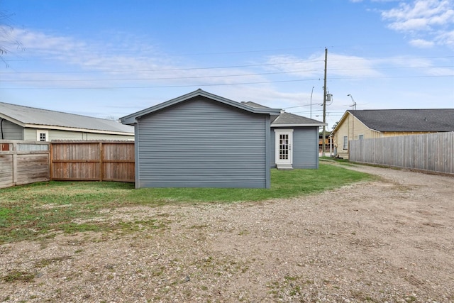 rear view of house featuring a lawn