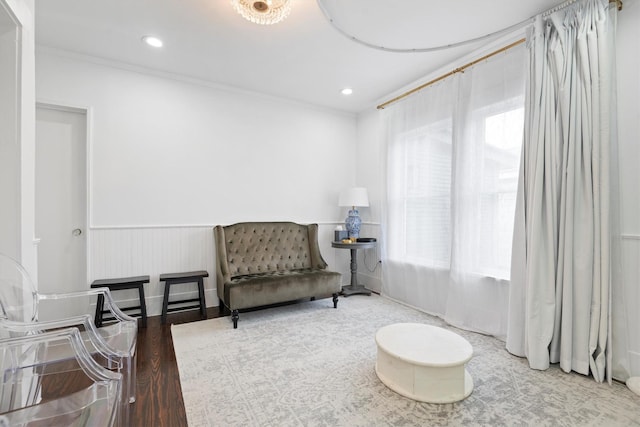 living area featuring ornamental molding, a healthy amount of sunlight, and hardwood / wood-style floors