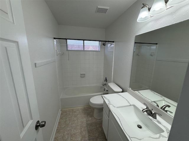 full bathroom with tile patterned floors, tiled shower / bath combo, vanity, and toilet