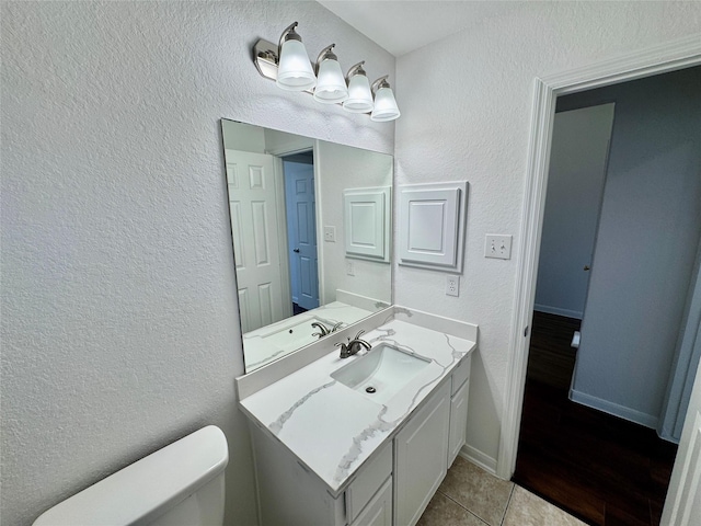 bathroom featuring toilet, vanity, and tile patterned floors