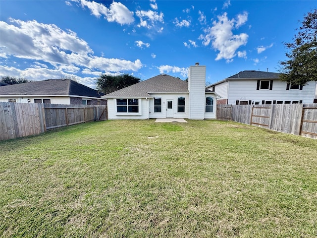 rear view of house with a lawn