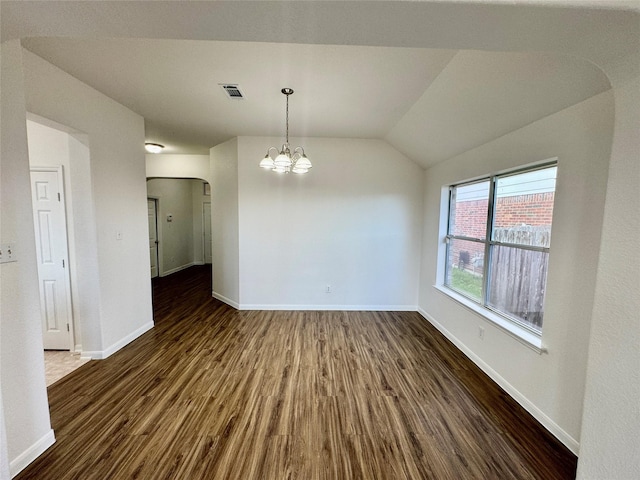 interior space featuring vaulted ceiling, dark wood-type flooring, and a notable chandelier