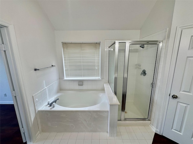 bathroom with lofted ceiling, tile patterned floors, and plus walk in shower