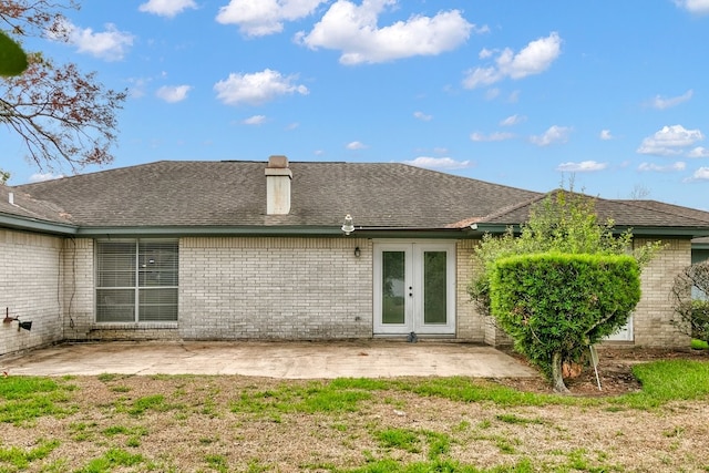 rear view of property featuring a patio area and french doors