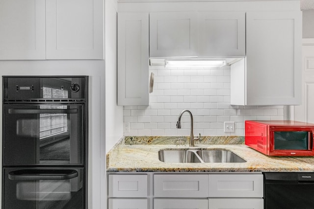 kitchen with sink, white cabinetry, backsplash, and black appliances