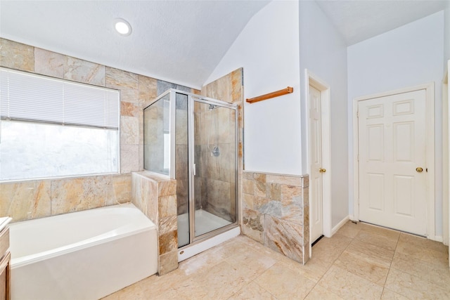 bathroom featuring separate shower and tub, vanity, and vaulted ceiling