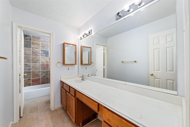 bathroom featuring a textured ceiling and vanity