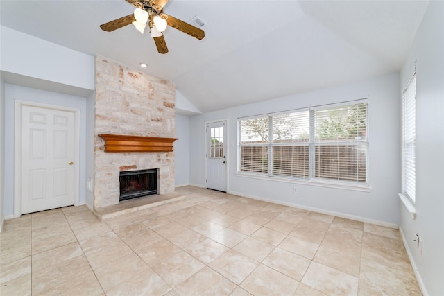 unfurnished living room featuring vaulted ceiling, light tile patterned floors, a fireplace, and plenty of natural light