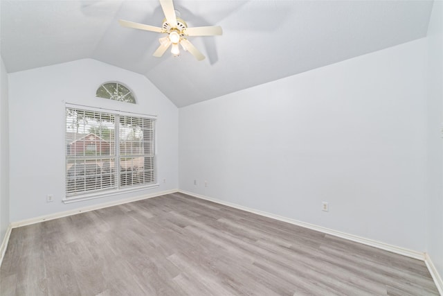 empty room featuring vaulted ceiling, ceiling fan, and light hardwood / wood-style flooring