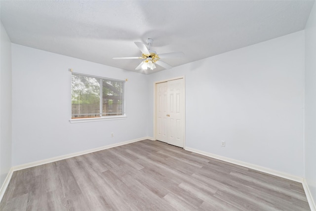 spare room with ceiling fan and light hardwood / wood-style flooring