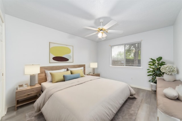 bedroom featuring ceiling fan and hardwood / wood-style flooring