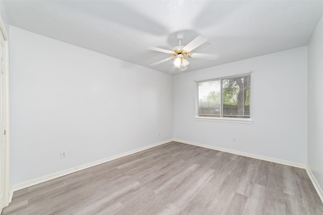 empty room featuring ceiling fan, light hardwood / wood-style floors, and a textured ceiling