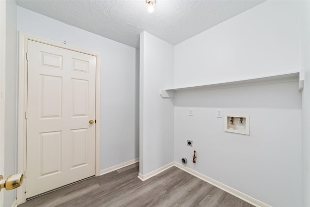 laundry room featuring washer hookup, wood-type flooring, gas dryer hookup, and electric dryer hookup