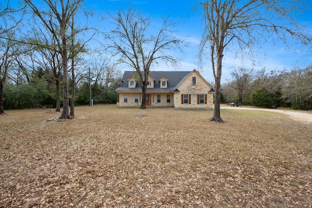 new england style home featuring a front lawn