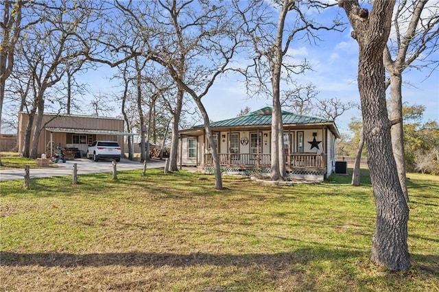 ranch-style house with a front lawn, a porch, and a carport