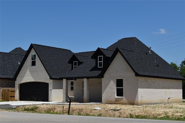 french provincial home featuring a garage