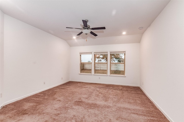 unfurnished room featuring carpet, vaulted ceiling, and ceiling fan