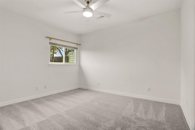 unfurnished room featuring ceiling fan and carpet