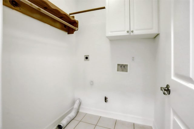 washroom featuring washer hookup, light tile patterned floors, hookup for an electric dryer, gas dryer hookup, and cabinets