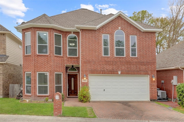 view of front of home featuring central AC and a garage