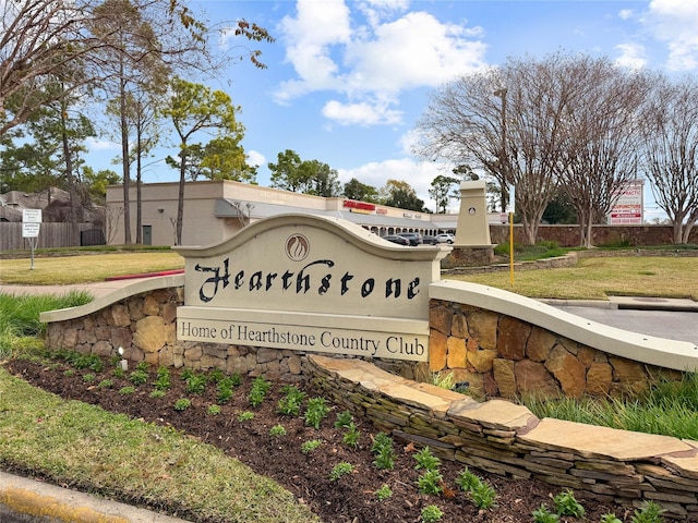 community / neighborhood sign with a yard