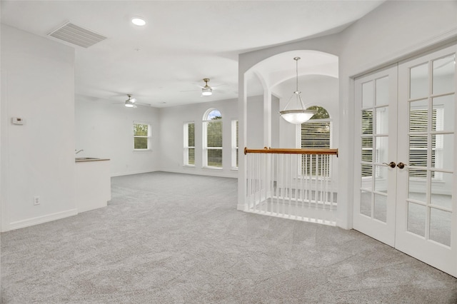 unfurnished room with ceiling fan and carpet