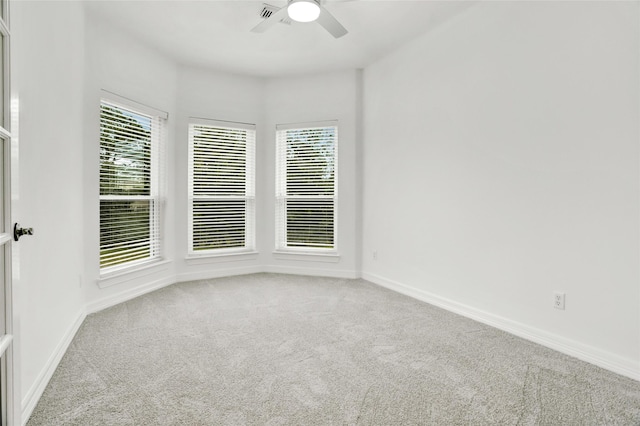 empty room with ceiling fan and carpet flooring