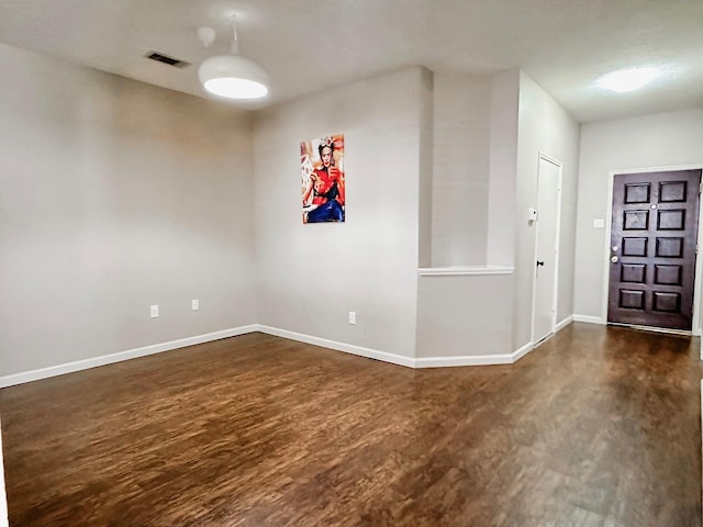 empty room featuring dark hardwood / wood-style flooring