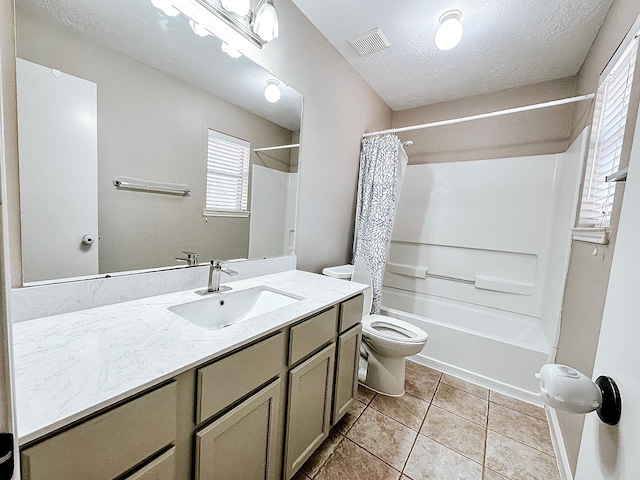 full bathroom with toilet, shower / bath combo with shower curtain, tile patterned flooring, a textured ceiling, and vanity