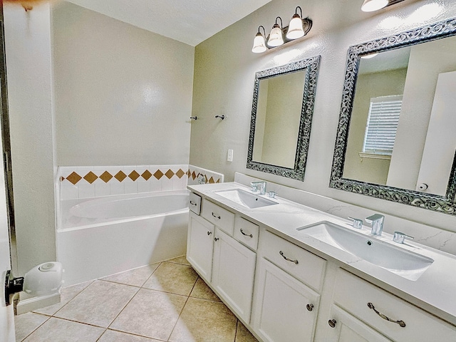 bathroom with tile patterned flooring, vanity, and a tub