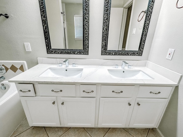 bathroom featuring a bathing tub, tile patterned floors, and vanity