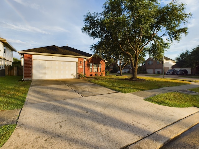 ranch-style house featuring a front yard, a garage, and central air condition unit