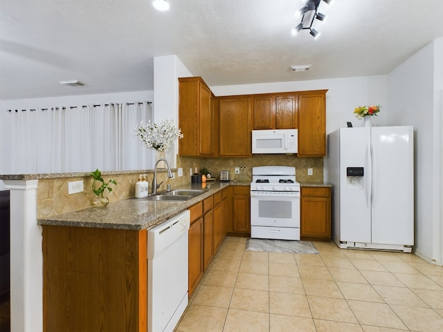 kitchen featuring kitchen peninsula, tasteful backsplash, white appliances, light tile patterned flooring, and sink