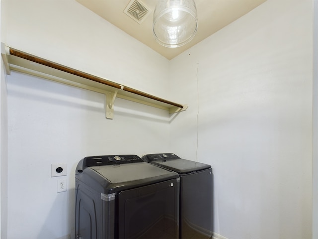 clothes washing area with separate washer and dryer