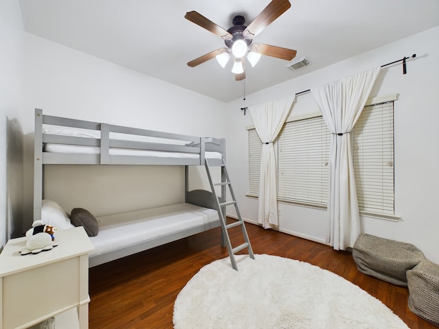 bedroom with ceiling fan and dark wood-type flooring