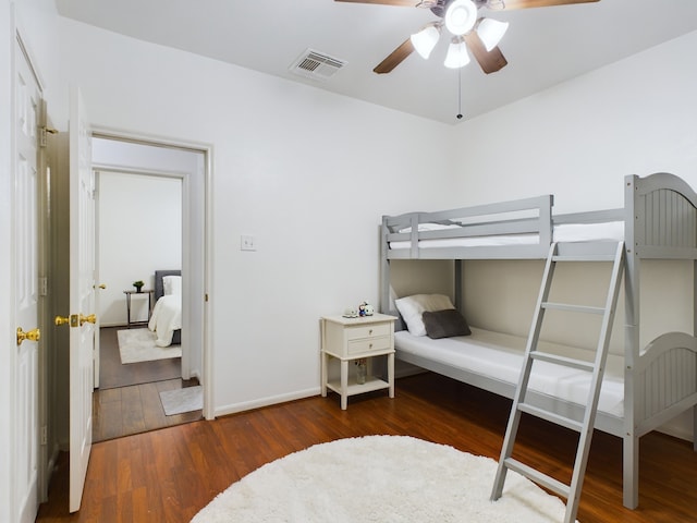 bedroom featuring dark wood-type flooring and ceiling fan