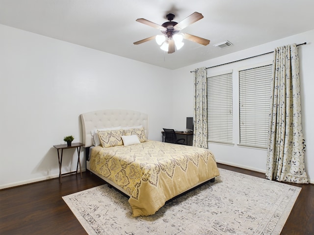 bedroom with ceiling fan and dark hardwood / wood-style floors