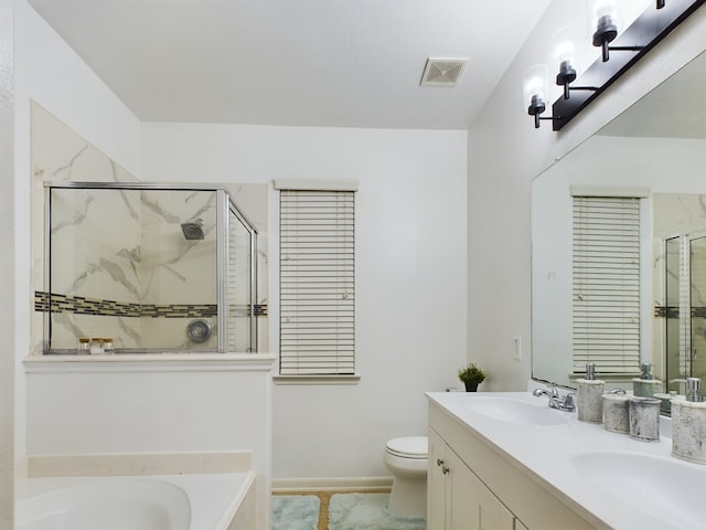 full bathroom with toilet, vanity, and independent shower and bath