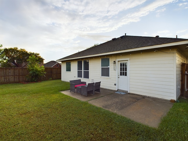 rear view of house with a patio area and a lawn