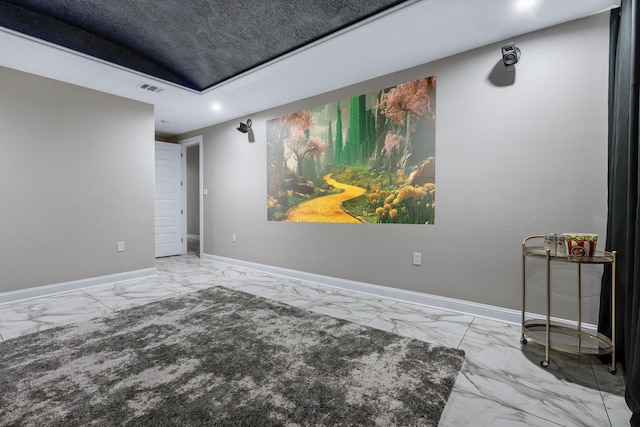 home theater featuring a raised ceiling